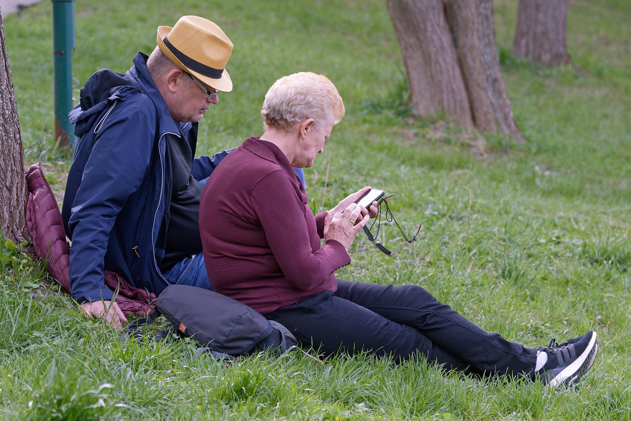 Elderly Indian couple smiling at a smartphone